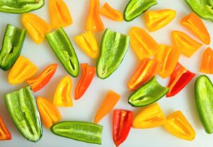 cut mini bell peppers on a cutting board